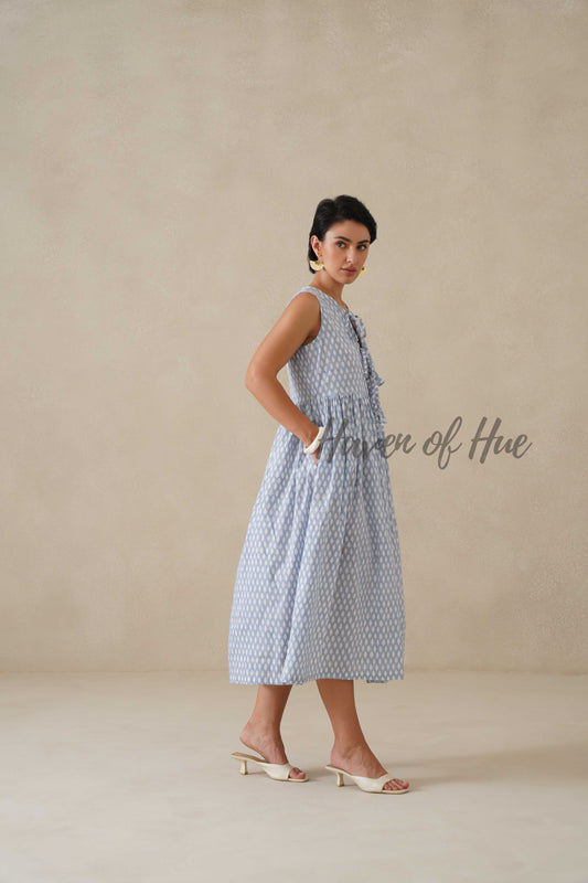 Back view of a relaxed fit blue cotton midi dress showing the flowy silhouette and modest length.
