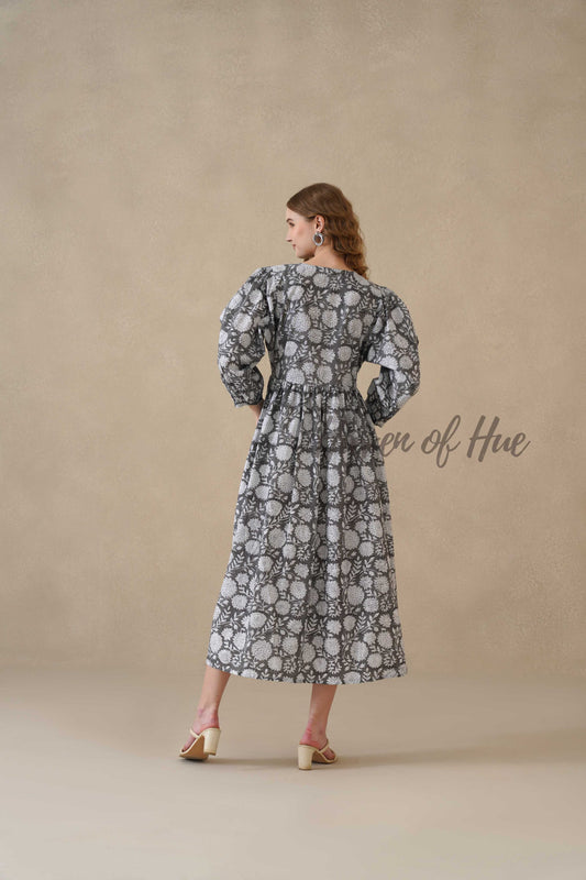 Close up shot of the intricate cream botanical motif on high-quality black cotton fabric.