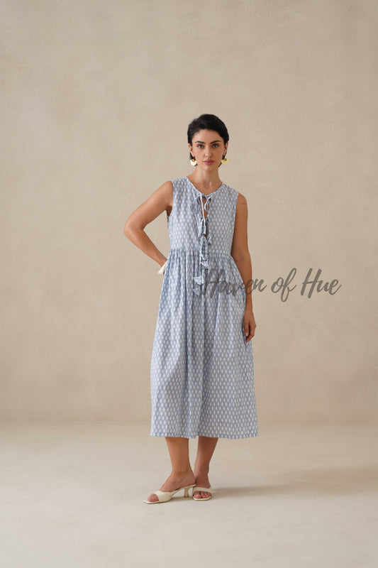 Front view of a woman wearing a blue and white geometric print cotton midi dress with sleeveless design.