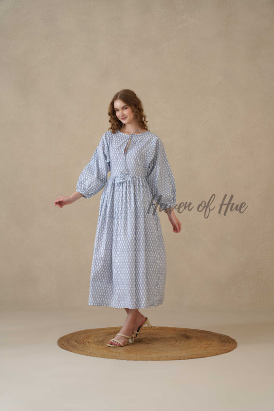 Detailed view of the white geometric teardrop pattern on high-quality dusty blue cotton fabric.